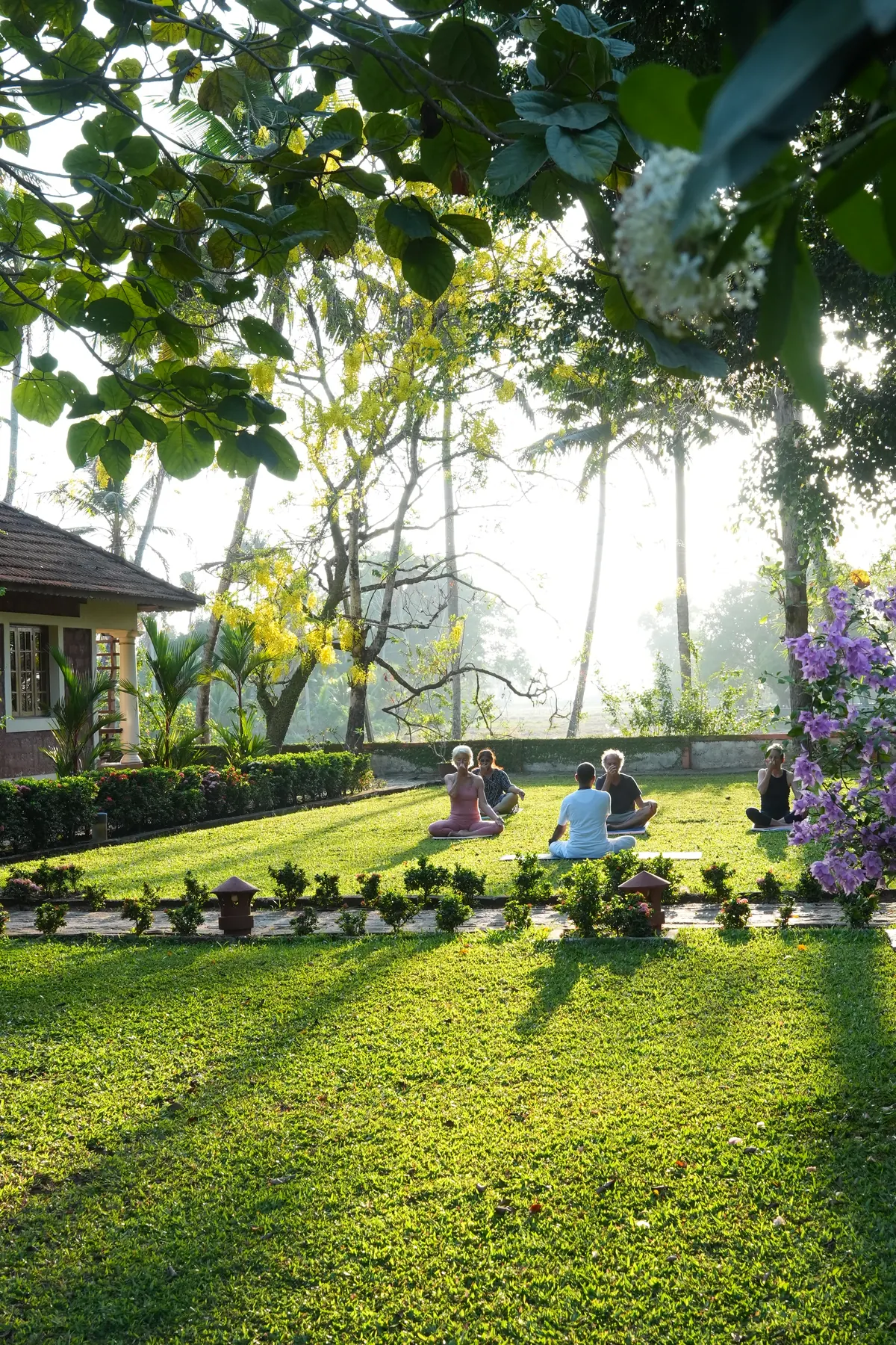 Morning yoga in the garden at Athreya Ayurvedic Centre