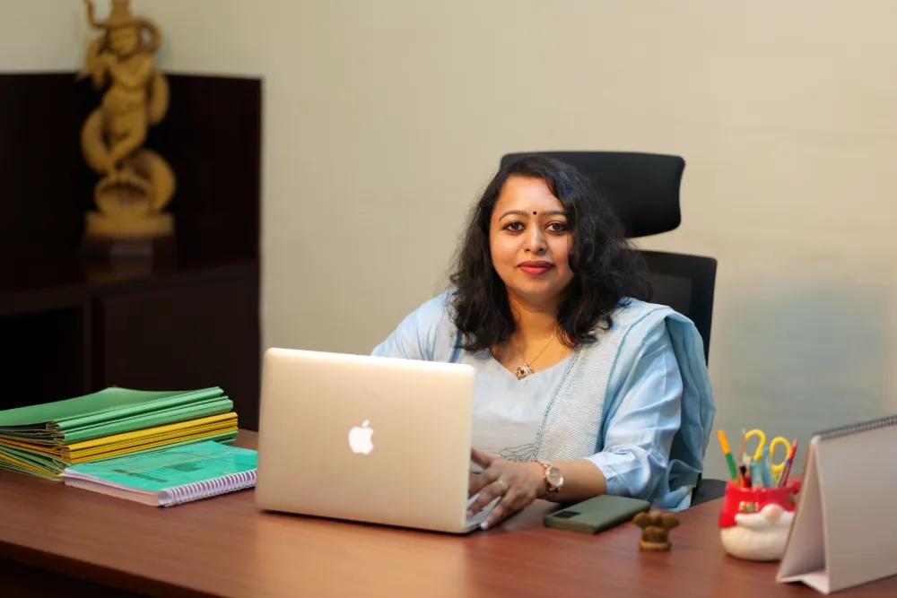 An Athreya physician at her desk reviewing a guest's notes