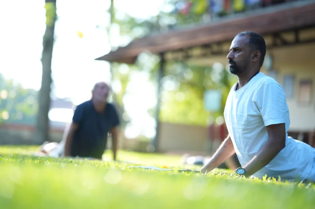Morning yoga on the lawn at Athreya Ayurvedic Centre