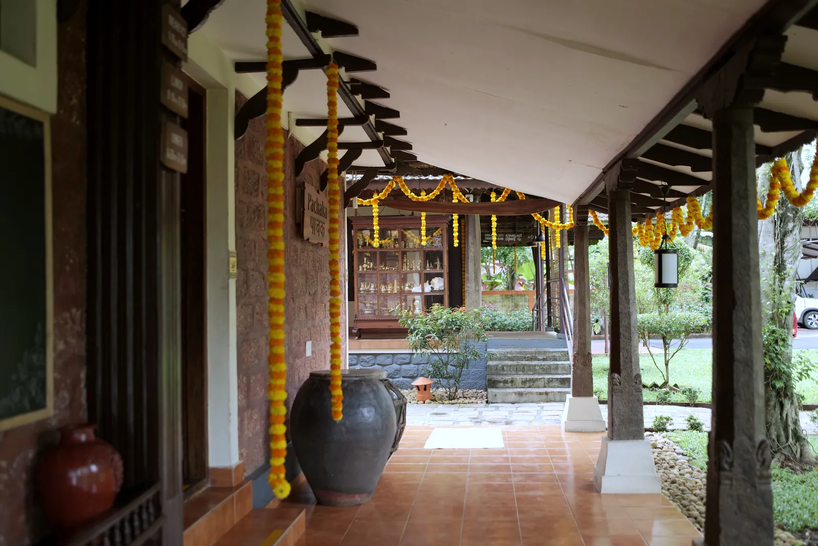 Garlanded verandah where guests rest after treatment at Athreya